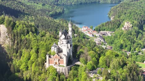 Breathtaking-panoramic-aerial-view-of-Neuschwanstein-Castle-with-the-beautiful-Alpsee-Lake-in-the-background