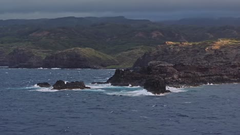 Rugged-coastline-of-Maui's-northwest-shore-with-crashing-waves-and-dramatic-cliffs