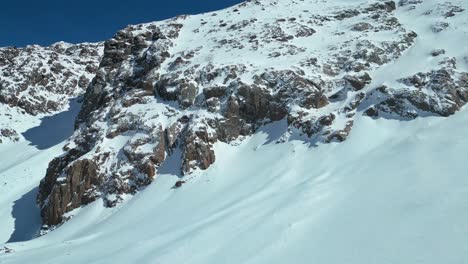 Mountain-summit-altitude,-drifting-pure-snow,-rock-formation-erosion