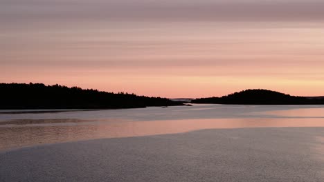 Pink-coloured-sunrise-between-islands-of-Sweden