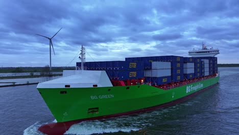 BG-Green-FreightLine-Voyage-With-Wind-Turbines-In-The-Background-Near-Barendrecht,-Netherlands