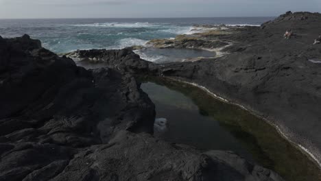 Rocky-shoreline-with-tidal-pools-at-Mosteiros,-Azores,-Sao-Miguel,-capturing-the-rugged-beauty-of-volcanic-rocks-and-the-Atlantic-Ocean