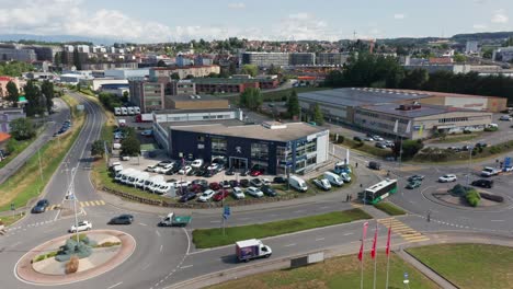 Drone-flying-away-from-car-dealership-on-a-busy-industrial-site