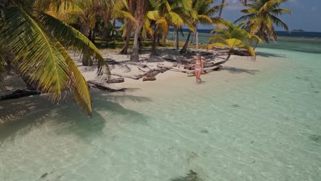 Blonde-girl-walking-in-a-beach-on-San-Blas-Islands-in-Panama