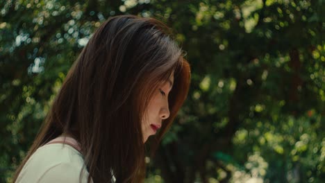 close-up-portrait-of-asiatic-female-young-woman-in-natural-outdoor-park