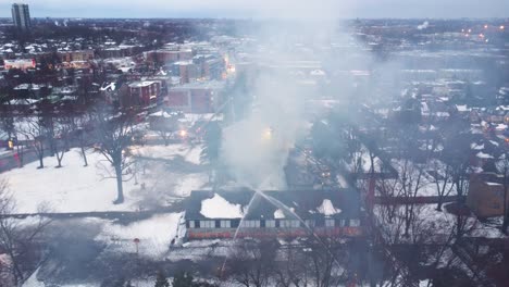 Aerial-view-firefighters-working-on-a-large-fire-into-a-school-in-Quebec-in-Canada