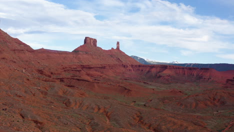 Aerial-view-over-the-sunny-a-red-rock-dessert-and-cloudy-landscape-view,-Moab-Tower