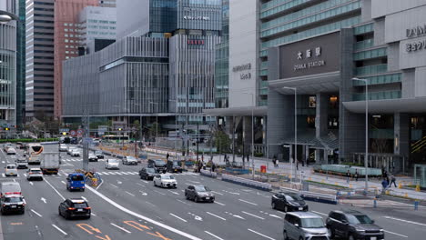 Busy-Urban-Street-in-Front-of-Osaka-Station,-Japan