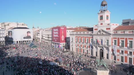 Pro-Palestine-protesters,-holding-a-balloon-depicting-a-bomb-and-Palestine-flags,-take-part-in-a-demonstration-to-demand-an-end-to-arms-sales-to-Israel-at-Puerta-del-Sol-in-Madrid,-Spain