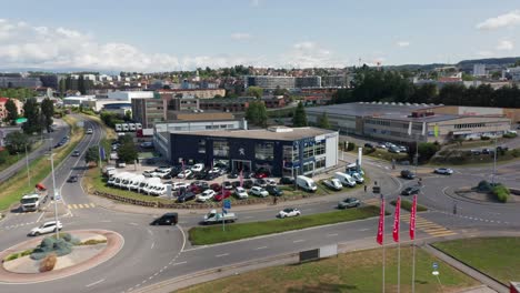 Drone-flying-towards-a-Peugeot-car-dealership-on-a-busy-industrial-site