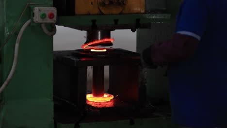 extreme-close-up-seen-putting-the-forging-parts-inside-a-big-bucket,-Industrial-safety-first-concept