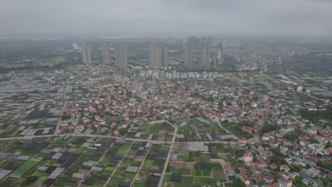 Aerial-drone-forward-moving-shot-flying-over-Hanoi-city-in-Vietnam-on-a-cloudy-day