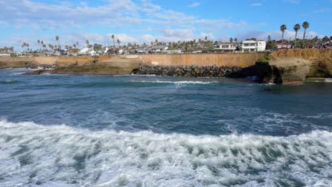 Olas-Del-Océano-Pacífico-Que-Fluyen-Hacia-La-Zona-De-Los-Acantilados-Al-Atardecer-De-San-Diego,-Vista-Aérea