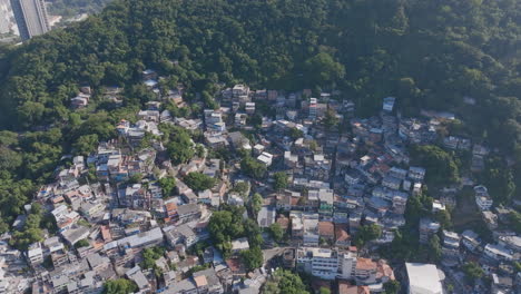 Aerial-flyover-of-a-favela-nestled-in-the-mountains-above-Copacabana-beach-in-Rio-de-Janeiro