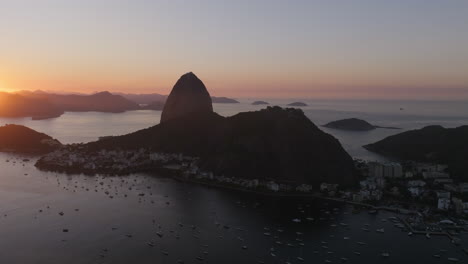 Aerial-footage-slowly-rotating-around-the-silhouette-of-Sugarloaf-mountain-during-the-sunrise-in-Rio-de-Janeiro-Brazil