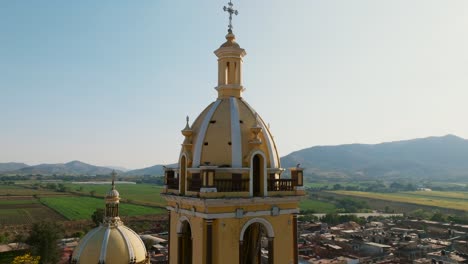 Slow-motion-aerial-orbit-view-of-the-Santuario-Diosesano-church's-bell-tower-in-Tamazula-de-Gordiano