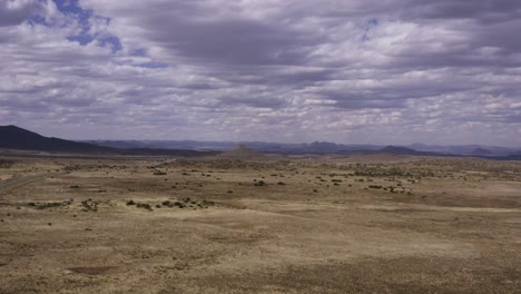 Aerial-Karoo-cloudy-desert-landscape,-tracking-back-4K