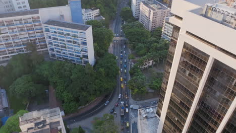 Aerial-footage-slowly-panning-up,-revealing-early-morning-traffic-waiting-to-go-through-a-tunnel-in-Rio-de-Janeiro-Brazil