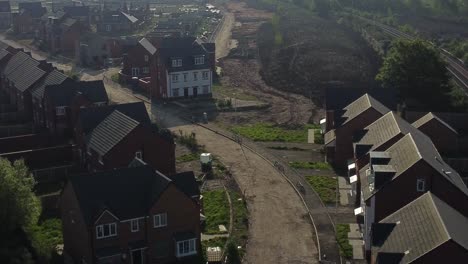 Abandoned-unfinished-housing-neighbourhood-estate-development-aerial-view-descending-above-real-estate-rooftops