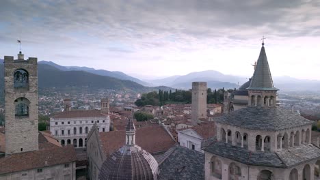 Long-aerial-shot-of-Bergamo-Alta-with-many-bell-towers-and-historic-buildings-starting-from-Angelo-Mai-Library