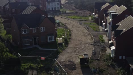 Abandoned-unfinished-housing-neighbourhood-estate-development-aerial-flyover-view-above-rooftops