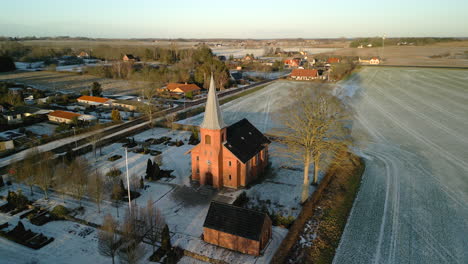 Aerial-of-church-at-sunset-in-winter