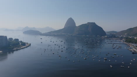 Aerial-footage-of-Botafogo-Bay-in-Rio-de-Janeiro-Brazil,-with-groups-of-boats-anchored-out-in-the-sea