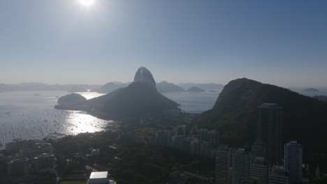 A-wide-aerial-shot-of-Botafogo-Bay-in-Rio-de-Janeiro-with-Sugarloaf-Mountain-in-the-background-silhouetted