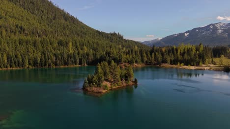 Orbital-view-of-small-island-in-the-middle-of-Gold-Creek-Pond-and-Evergreen-forest-in-Washington-State