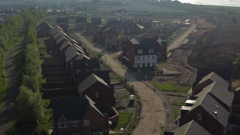 Abandoned-unfinished-housing-neighbourhood-estate-development-aerial-view-orbiting-real-estate-rooftops