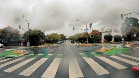 Rainy-day-drive-through-suburban-neighborhood-on-a-motorcycle