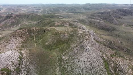 The-old-town-of-belchite-in-zaragoza-spain-showcasing-rolling-hills-and-ruins,-aerial-view