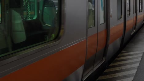 Train-arrives-and-slowing-to-a-stop-at-a-train-station-in-rural-Japan