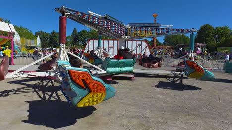 Fall-Fair-Medium-shot-pans-against-ride-spinning-people-around-just-off-the-ground