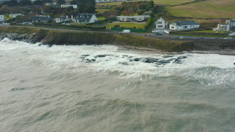 Aerial-view-of-waves-crashing-against-rocks-along-the-coastline-during-a-storm