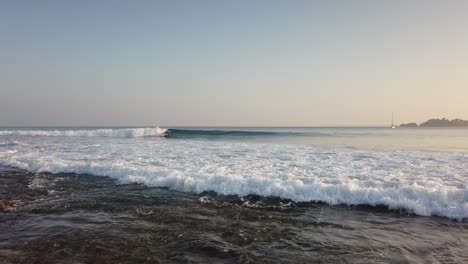 Surfer-at-Butler-Bay-at-Sunset,-Little-Andaman,-Andaman-Islands,-India