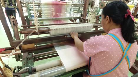 Weaving-a-traditional-Thai-dress-on-an-old-wooden-loom-at-the-Jim-Thompson-Silk-farm-in-Nakhon-Ratchasima-Thailand