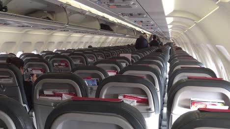 Handheld-shot-of-a-commercial-plane-cabin-whilst-boarding