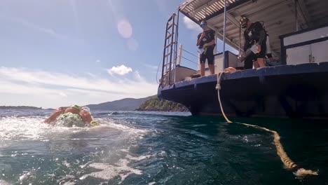 Eine-Statische-Aufnahme-Eines-Mannes,-Der-Von-Einem-Boot-Steigt,-Um-Ins-Meer-Zu-Tauchen