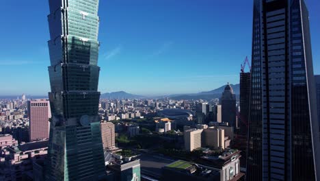 Aerial-pullback-next-to-Taipei-101-on-a-sunny-morning-with-clear-sky