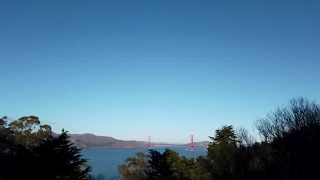 View-from-bushes-from-afar-of-the-Golden-Gate-Bridge-and-sea