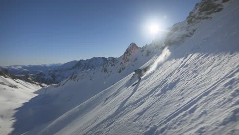 amazing-skier-skiing-down-a-steep-powder-snowy-slope-in-slow-motion-with-an-incredible-winter-mountain-background-with-blue-sky