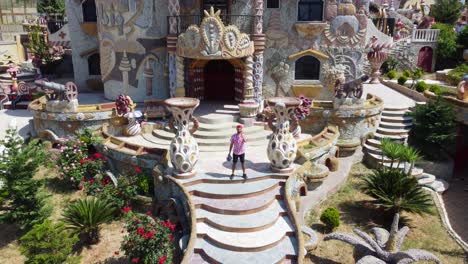 Lebanese-Man-Stands-At-The-Entrance-Of-Palace-Of-Dreams-In-Bakhoun,-Lebanon