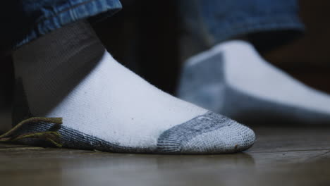 Close-Up-of-man-putting-on-work-boots