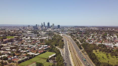 Aerial-wide-shot,-Mitchell-freeway-and-Perth-city,-Australia