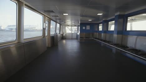 An-empty-ferry-boat-on-the-waters-of-Amsterdam,-Netherlands-due-to-the-corona-virus-spread---wide-rolling