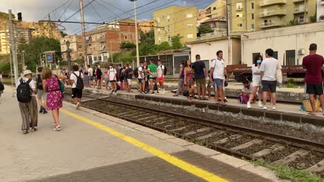 People-Waiting-on-a-Railroad-Track-Platform-at-a-Busy-Train-Station-in-Italy