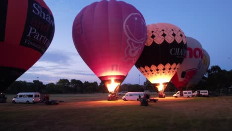 Drone-flying-toward-Hot-air-balloons-while-they-are-inflating-before-takeoff