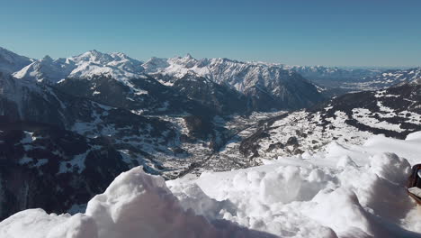 Looking-up-at-the-snow-covered-jagged-Montafon-mountain-range-and-valley,-Austrian-Alps,-slow-motion