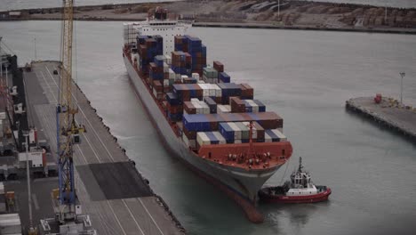 Cargo-Ship-leaving-small-Port-docking-with-Tug-Boat-assistance